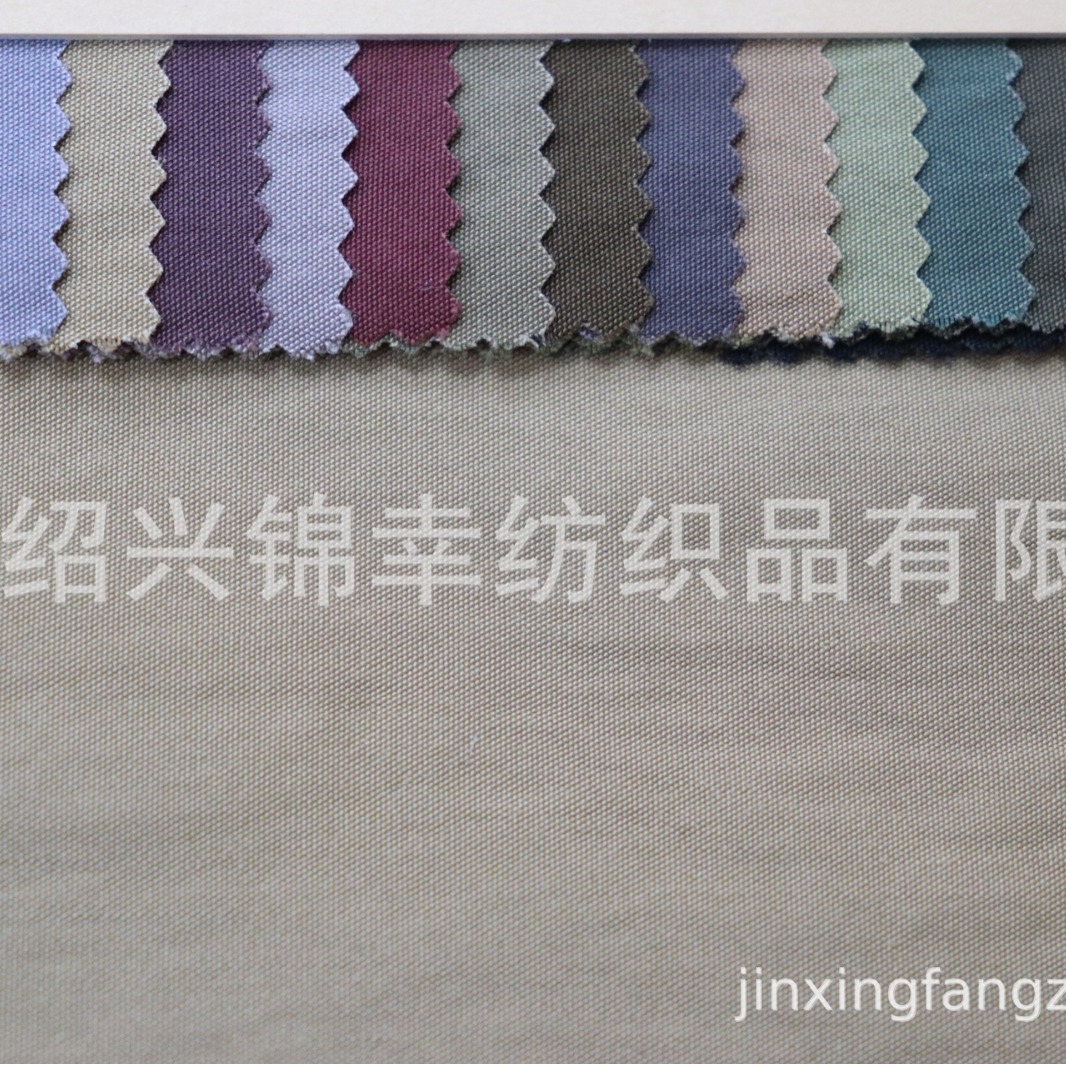 现货新款N/R布锦粘平纹交织休闲裤服装面料加厚180克棉锦皱风衣布