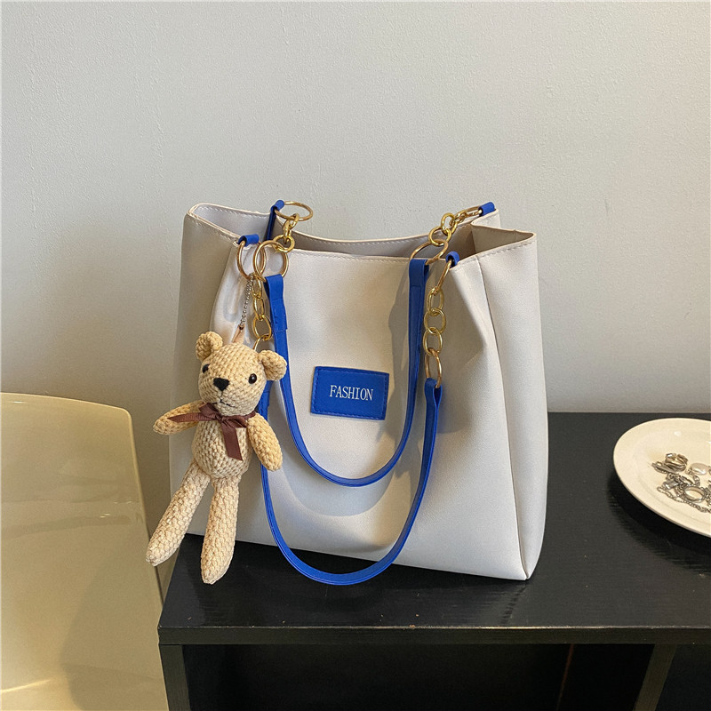 Bolsa de asas de gran capacidad de textura popular de este año para mujeres 2023 nueva moda casual estudiante bolsa de clase bolsa de cercanías