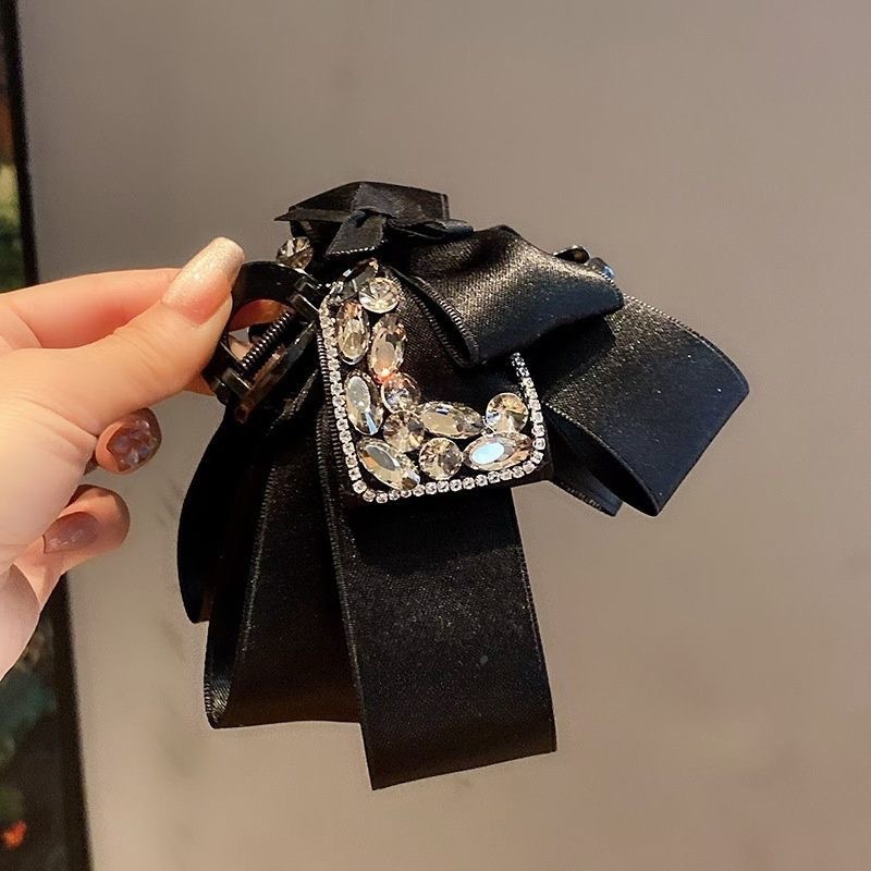 Elegant hårklämma med rosett och glittrande stenar för dam_voghion.com