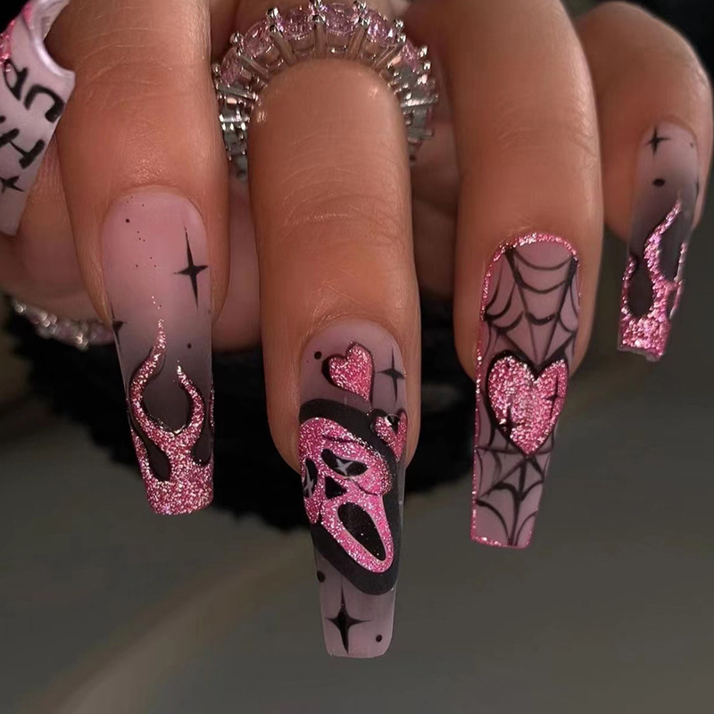 Pink glitter Halloween press-on nails with gothic dark spider web, flame, and screaming face designs Pink glitter Halloween press-on nails with gothic dark spider web, flame, and screaming face designs