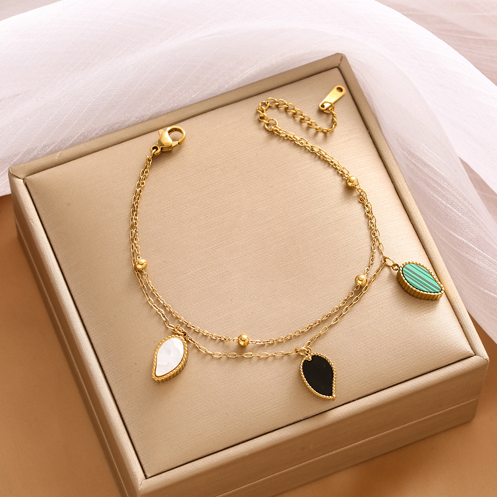 Pulsera de trébol de acero titanium vendedora caliente transfronteriza europea y americana con incrustaciones de concha pulsera colgante pulsera de diseño avanzado sin desvanecimiento al por mayor