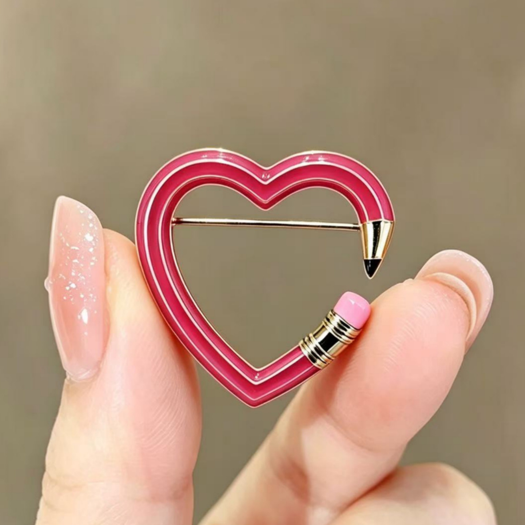 Cross-border best-selling creative heart-shaped pencil brooch, fun hollow-out enamel pin, niche cute item available for wholesale