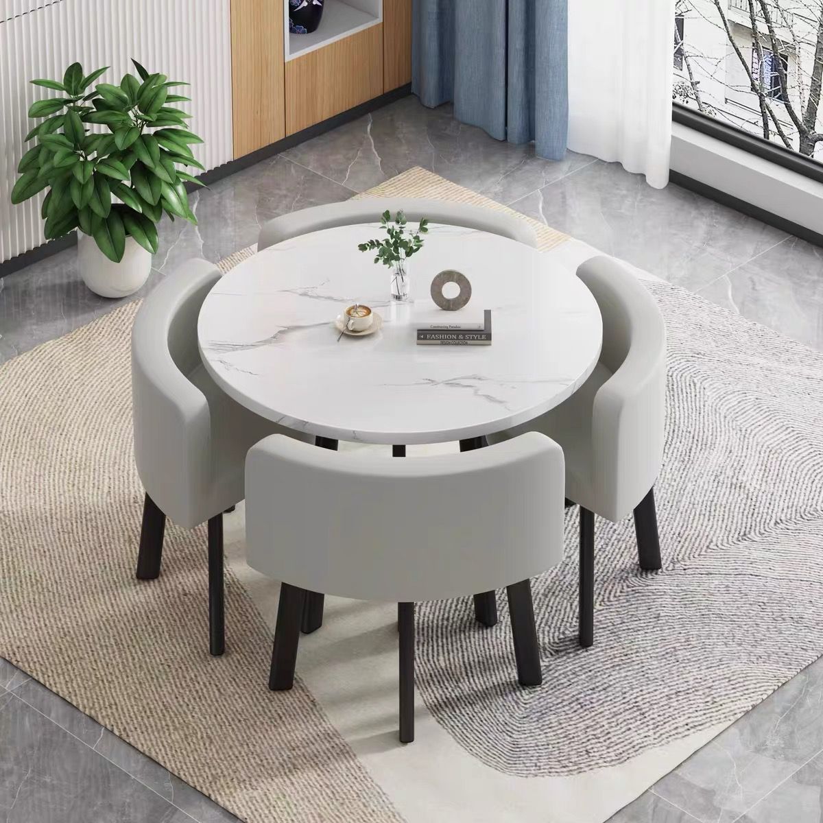 White round table + four light gray leather chairs