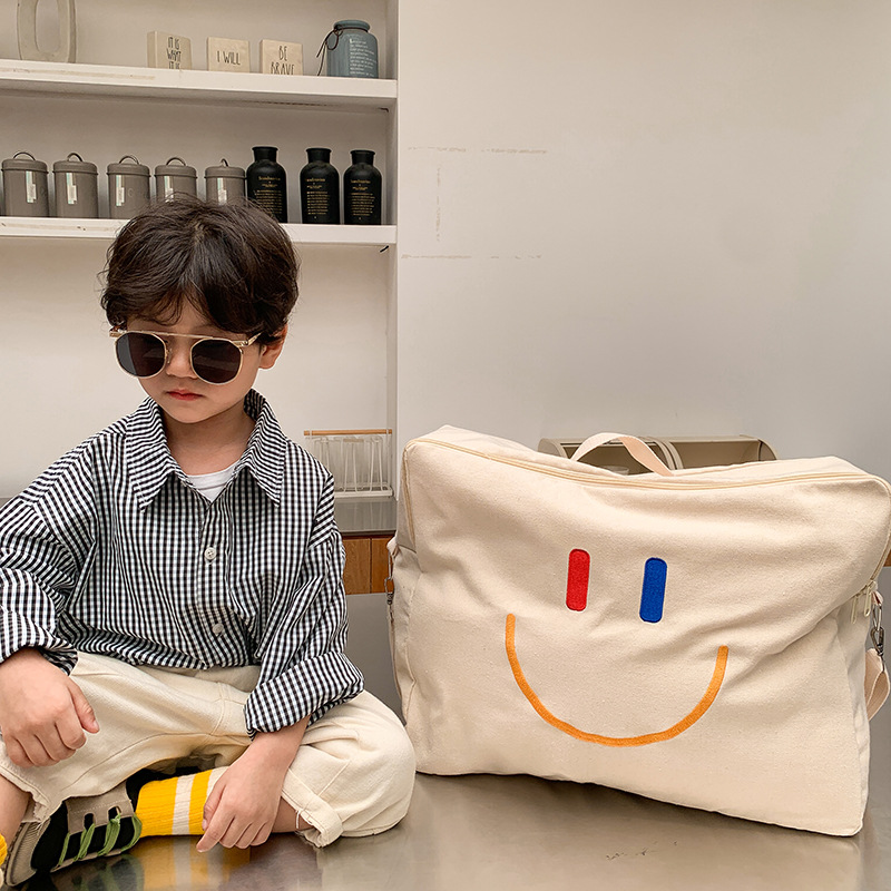Bolsa Infantil Otoño/Invierno 2025, Nueva Bolsa con Cara Sonriente, Bolsa de Hombro de Lona de Gran Capacidad, Bolsa de Almacenamiento de Edredones Portátil para Jardín de Niños