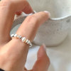 Round beads from pearl, ring, silver 925 sample, simple and elegant design, on index finger