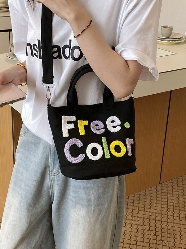 Mamá bolso para salir bolso de cubo de mano mujer 2026 nuevo bolso de lona bordado de dibujos animados letras casuales bolso de mochila