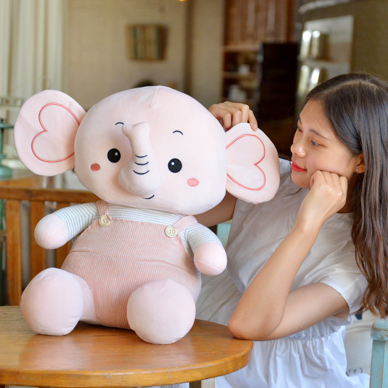 Caricatura muñeca elefante muñeca muñeca de peluche muñeca elefante muñeca niños calmar muñeca almohada en la cama