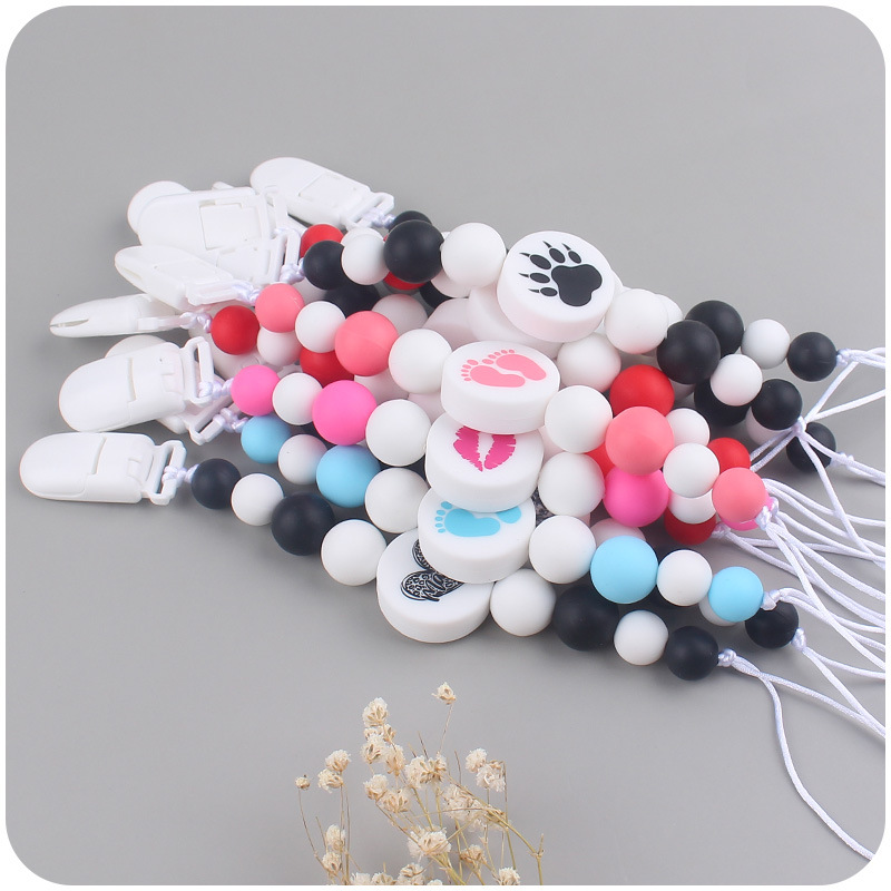 Nuevo bebé suministros de dibujos animados de impresión redonda amor creativo DIY silicona mordedura molar pezón cadena anti-caída