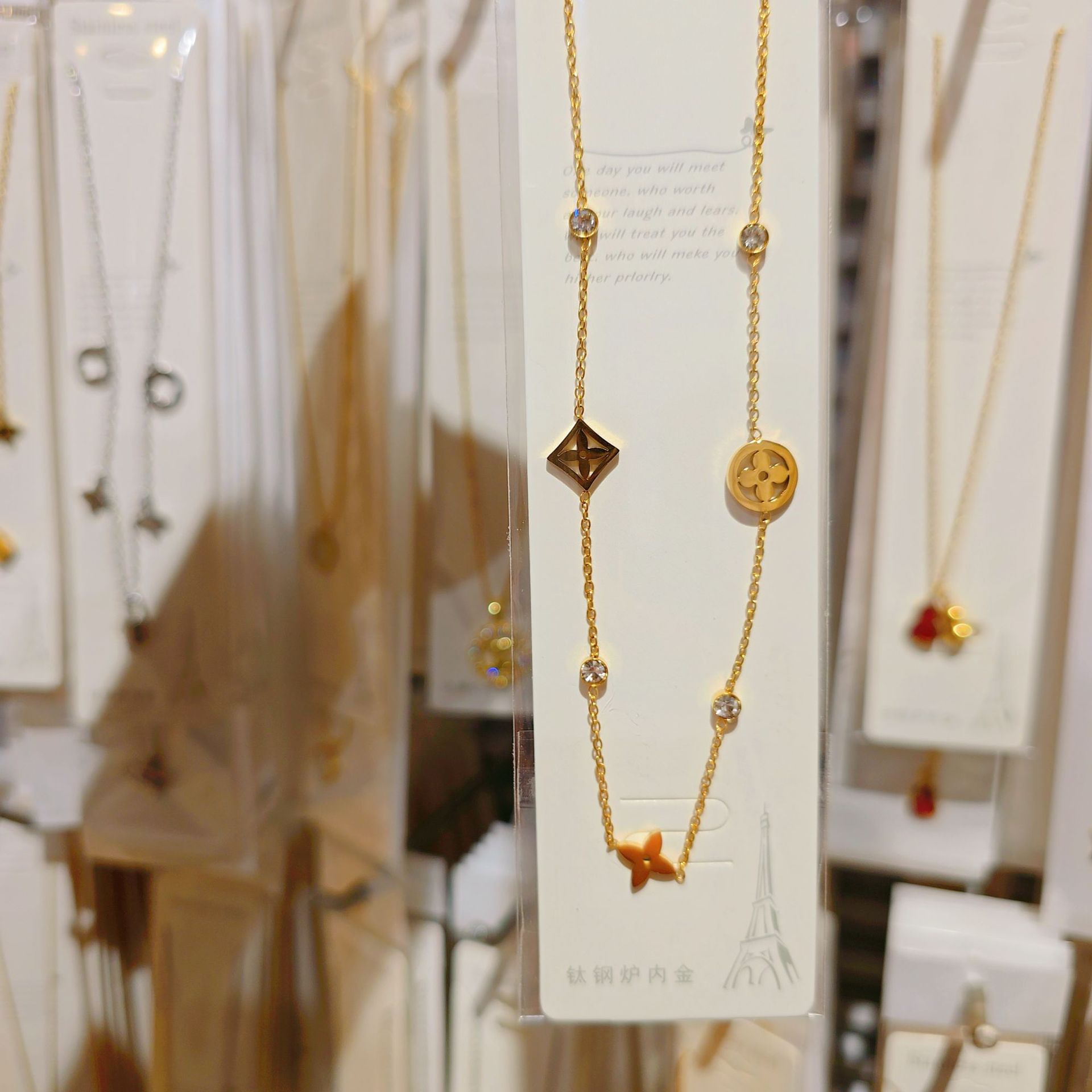 Golden necklace with zircon, four-leaf clover