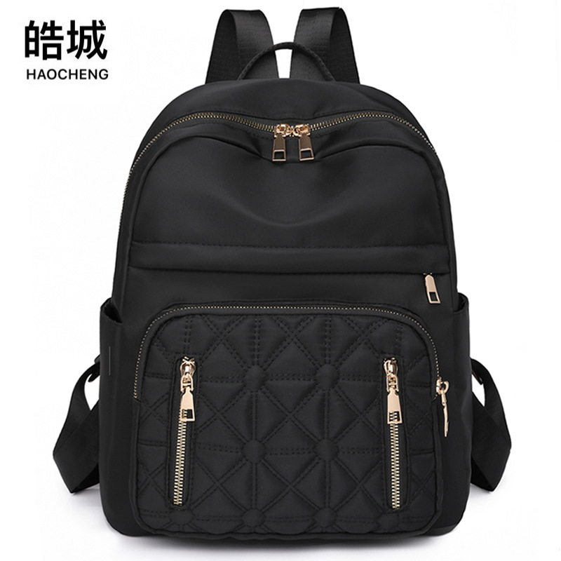 Comercio exterior al por mayor 2023 nueva versión coreana de la mochila de nailon para mujer, línea de bordado de moda, mochila de viaje al aire libre de todo fósforo, marea