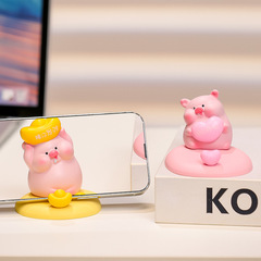 かわいい子豚の携帯電話のスタンドのデスクトップのアイデアの置物を解凍します。
