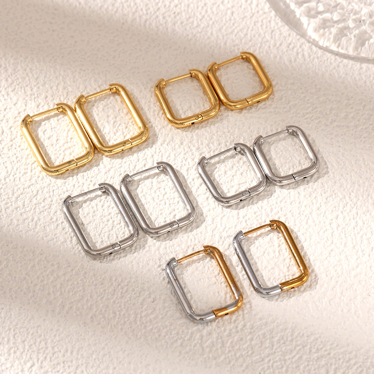 TENA Europa y los Estados Unidos venta transfronteriza aretes de acero inoxidable lujoso ligero de alto nivel brillante superficie de acero dorado joyas de orejas