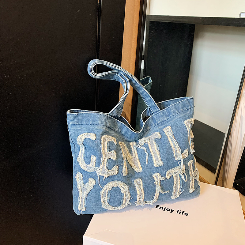 Nueva mochila de hombro de mezclilla retro, bolso de lona con letras de ocio, bolso de viaje artístico para estudiantes