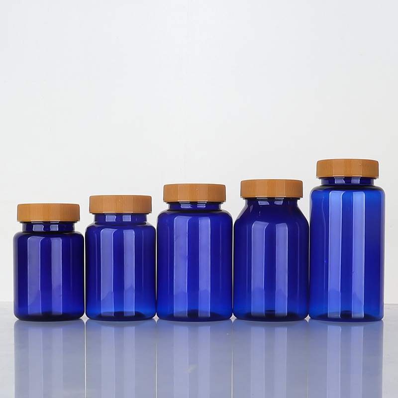 Botella de plástico azul 80–150 ml con tapa estriada, envase para suplementos o cápsulas.