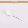 Large spoon holding dew on a jade plate