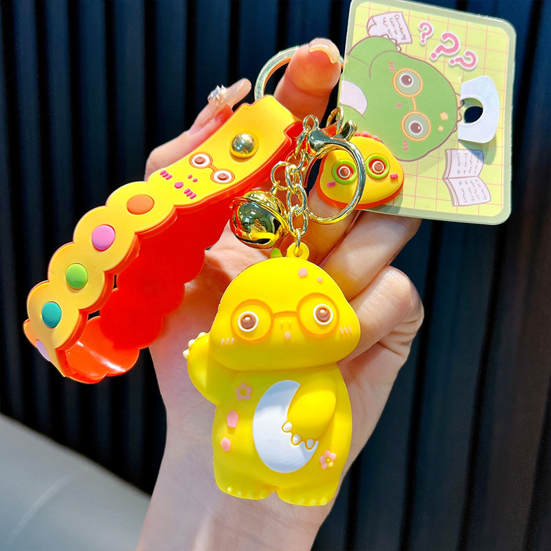 Keychain dinosaurio auténtico lindo bolso colgante de goma blanda llavero de automóvil muñeca pequeña máquina de regalos al por mayor image 8
