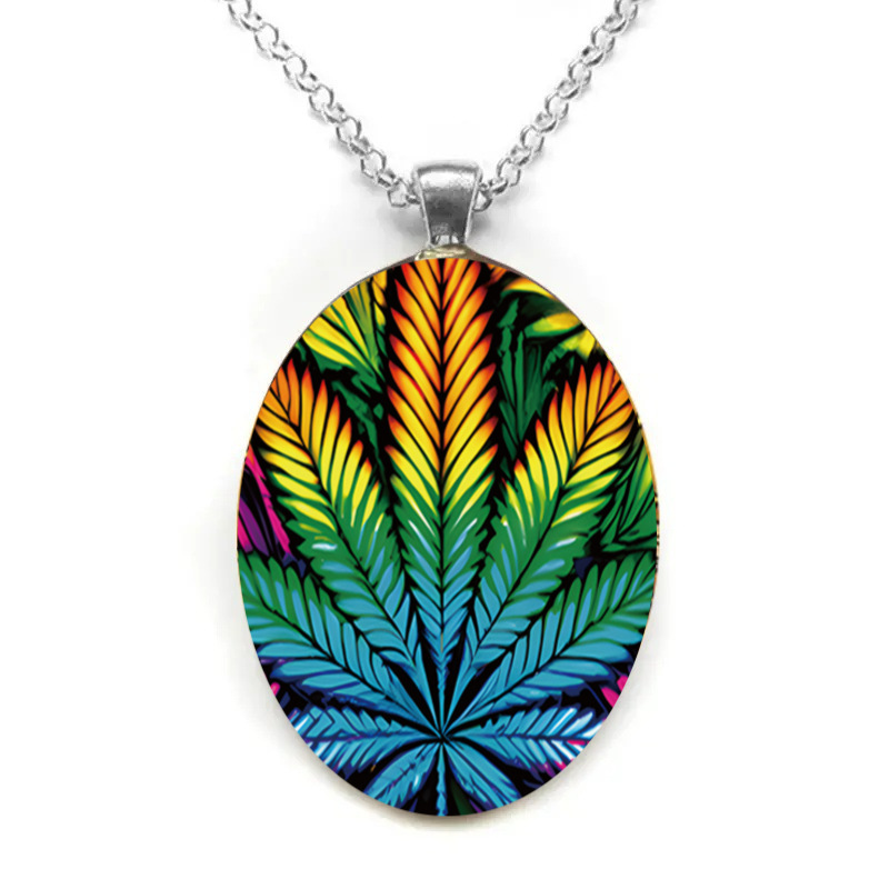 Oval glass pendant necklace with exaggerated leaf pattern