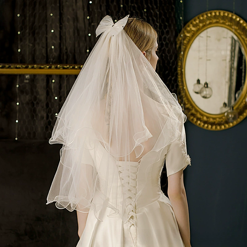 Cute short white bride's veil with bow