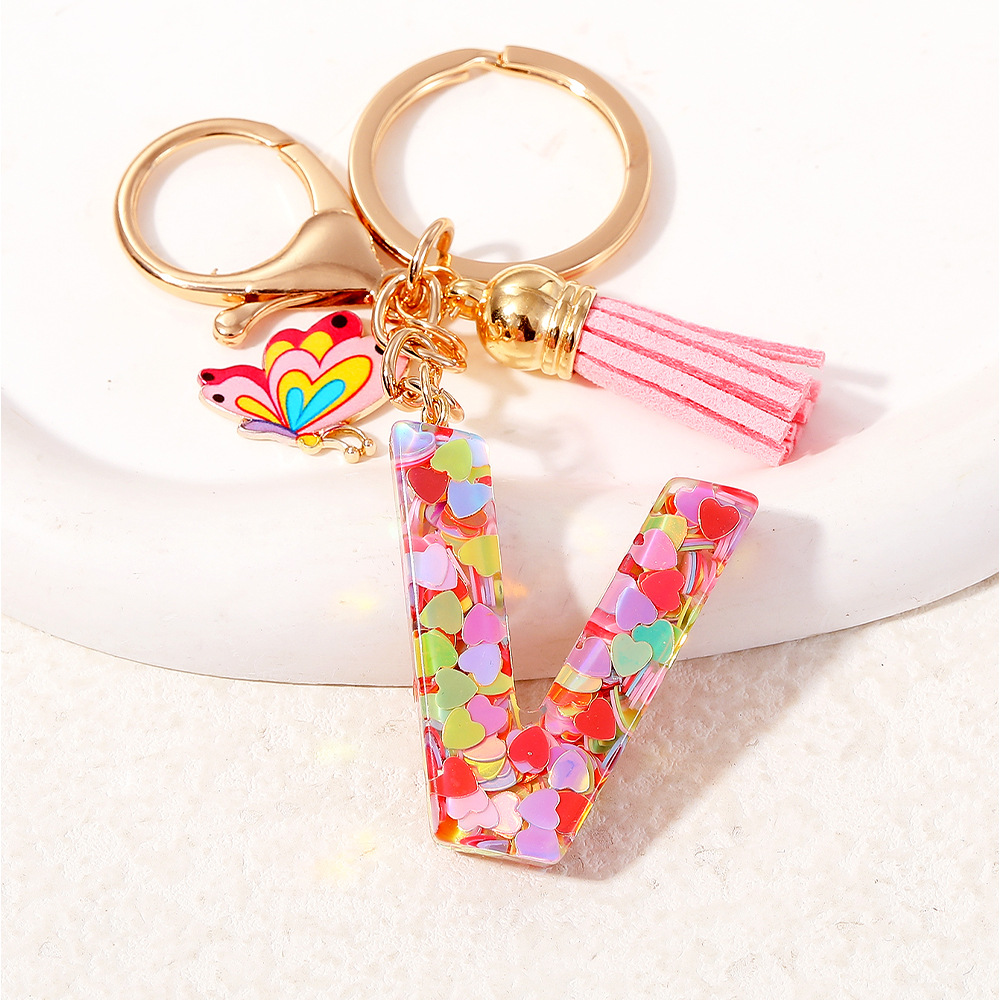 2024 puntos transfronterizos de resina de sequilla rosa 26 letras inglesas llavero colgante mariposa fringe accesorios