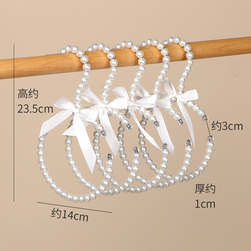 Tienda de ropa de mujer perla lujo ligero vestido retro arco adulto percha de ropa infantil estilo europeo hadas soporte de abrigo