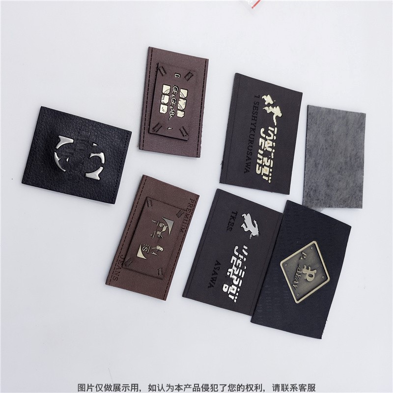 皮革包镶嵌五金皮标  订做热熔胶高频复合皮标金属商标在里面