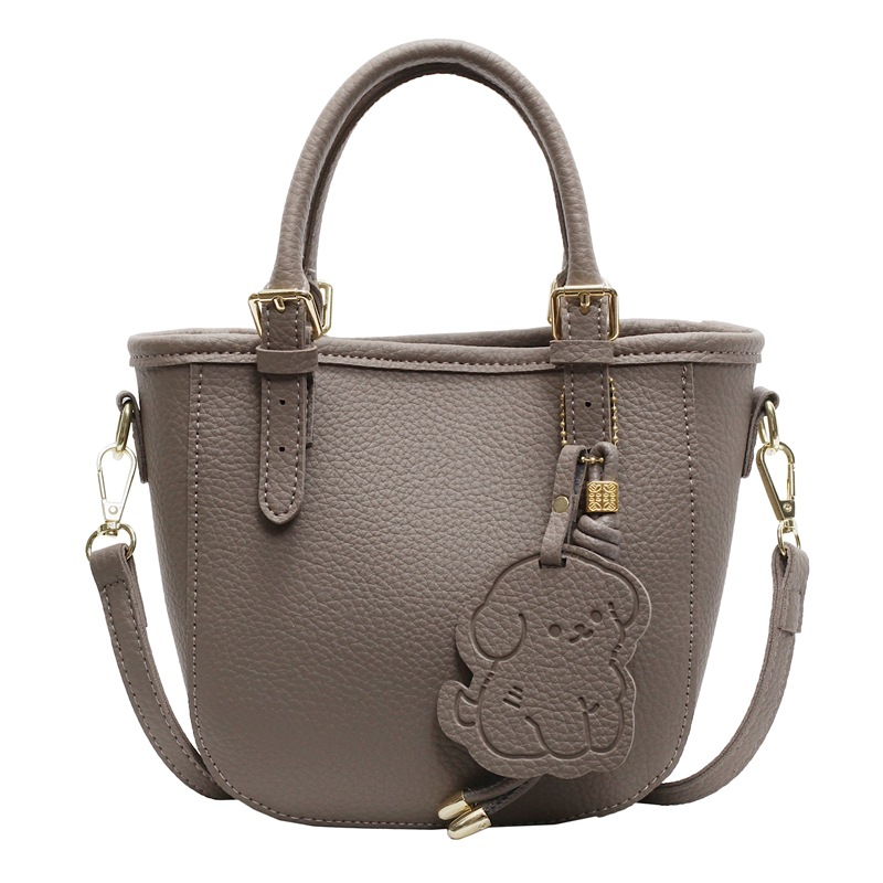 Bolsa de cubo portátil de comercio exterior 2025 nuevo bolso de mochila de textura universal nicho de diseño de red de popularidad explosiva bolso de hombro