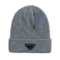 Triangular light gray knitted hat