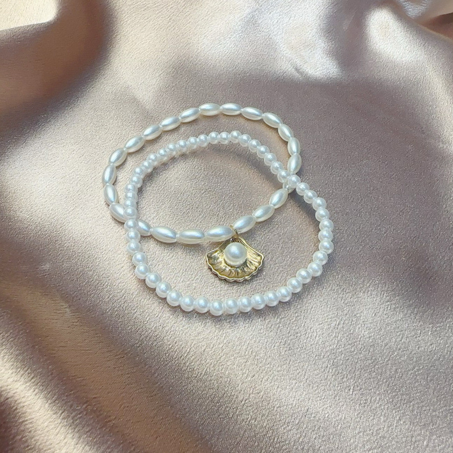 Europeo y americano transfronterizo nuevo simple perla artificial ventilador Shell colgante toblera creativo retro simple elástico toblera