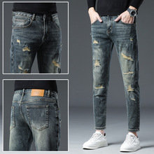 新塘秋冬新款破洞贴布水洗牛仔裤男潮流修身小脚潮男时髦长裤子男