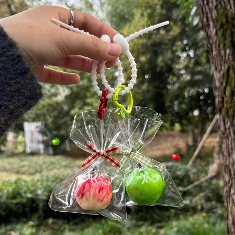 A large apple-shaped fun and creative bag charm, a popular gift for couples, a trendy keychain for students, and a girly accessory.