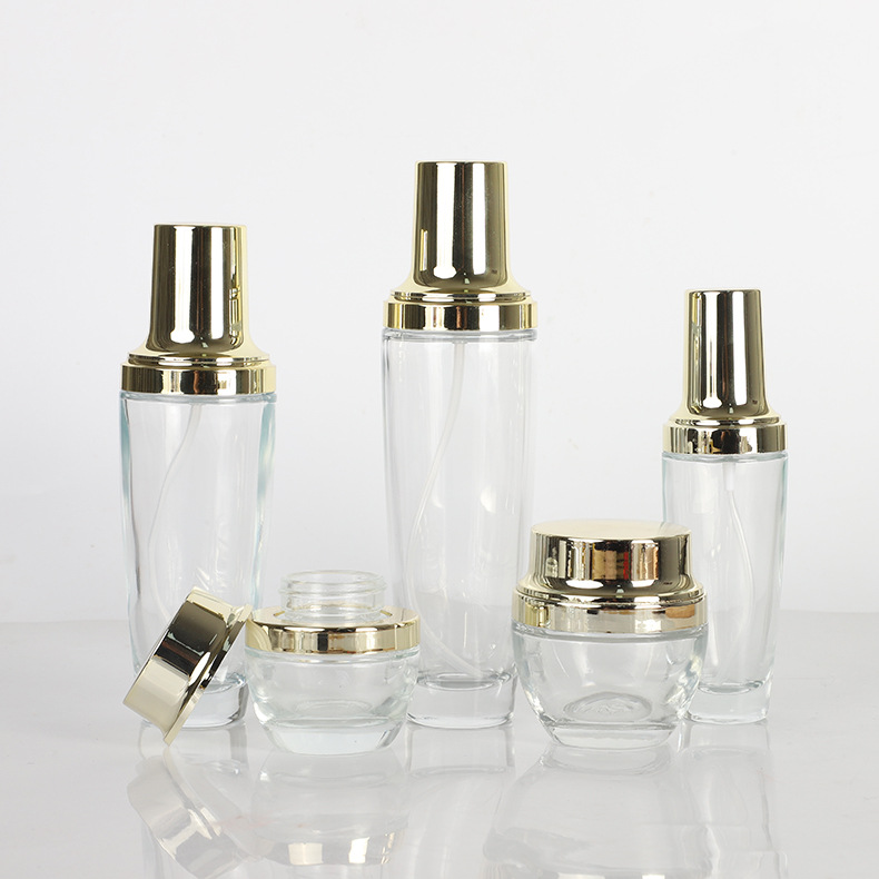 Tapa de oro transparente botella de vidrio esencia botella de loción crema cosmética crema conjunto botella aceite esencial sub-embalaje botella de spray