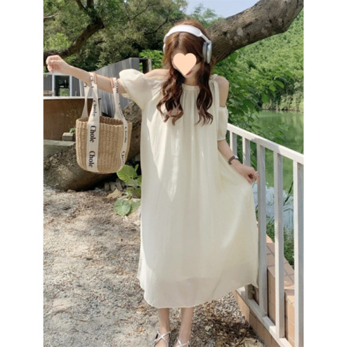 Elevated maternity dress for summer: chic, laid-back design with delicate cutouts and an off-shoulder neckline—perfect for a stylish, mid-length summer look.