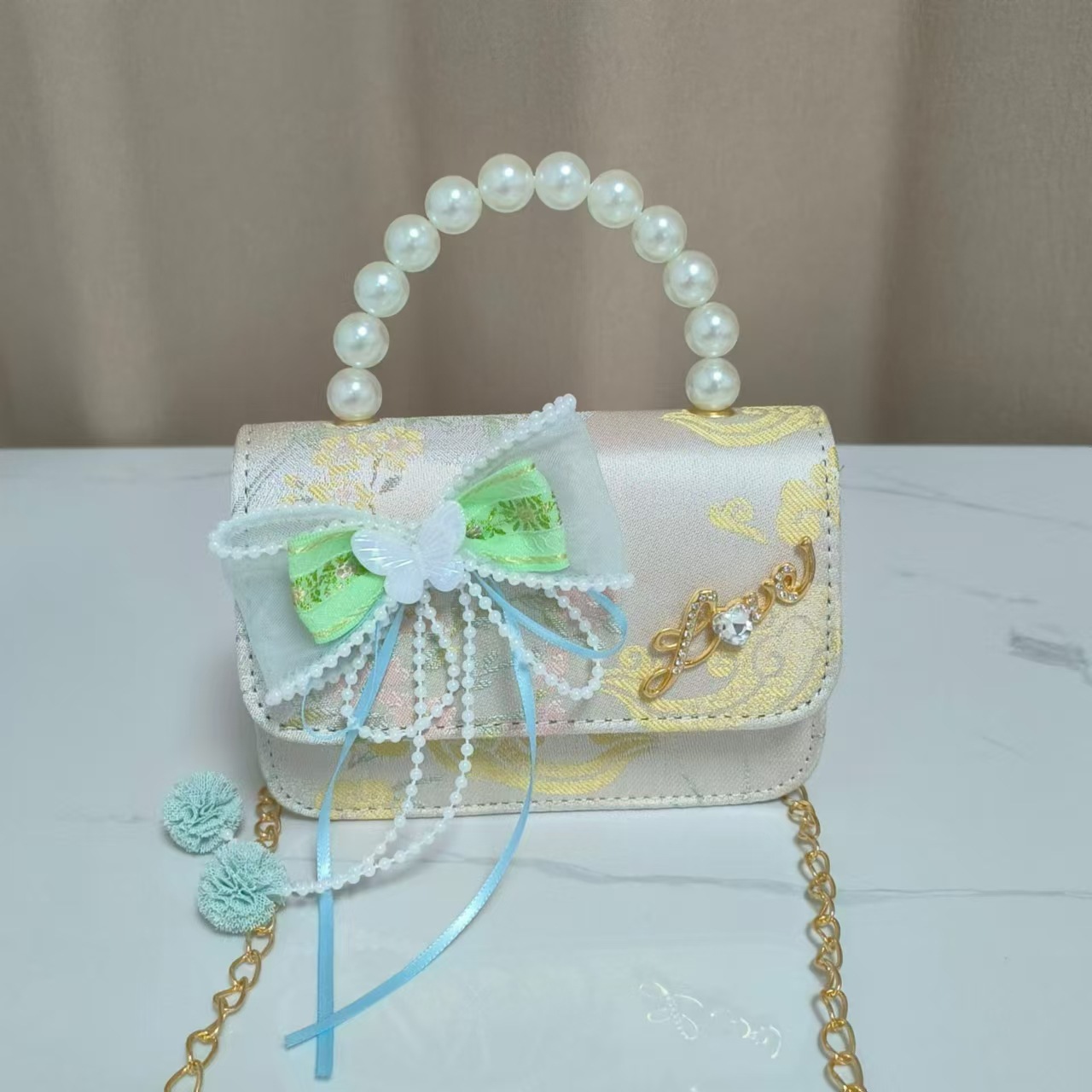 Bolsos infantiles de alto nivel antiguo bolso de cambio de niña pequeña princesa de perlas accesorios de ropa Han bolso de almacenamiento