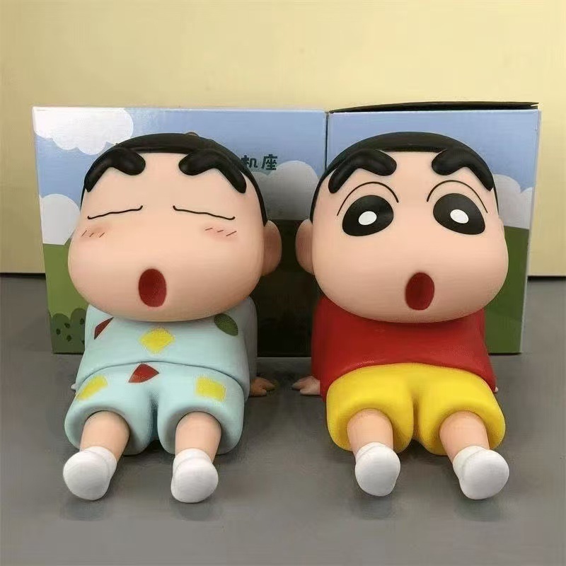 クレヨンしんちゃんの携帯電話スタンドの怠け者がデスクトップの置物を作っています。|undefined
