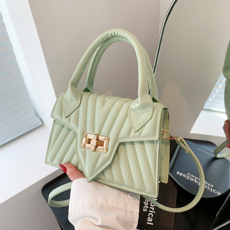 Textura 2025 nueva moda de impresión de estilo extranjero rotary-lock mochila de hombro casual color caramelo bolso de mano de mujer