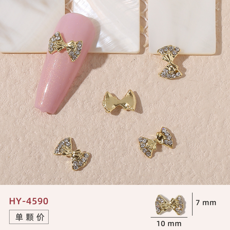 Uñas mariposa joyería nueva línea popular perla arco metal decoración de uñas pequeños accesorios de joyería al por mayor