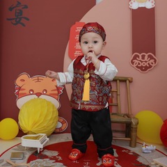 Red Chinese Hanfu for a one-year-old boy's birthday celebration, including traditional clothing and headgear, reflecting Chinese cultural style.