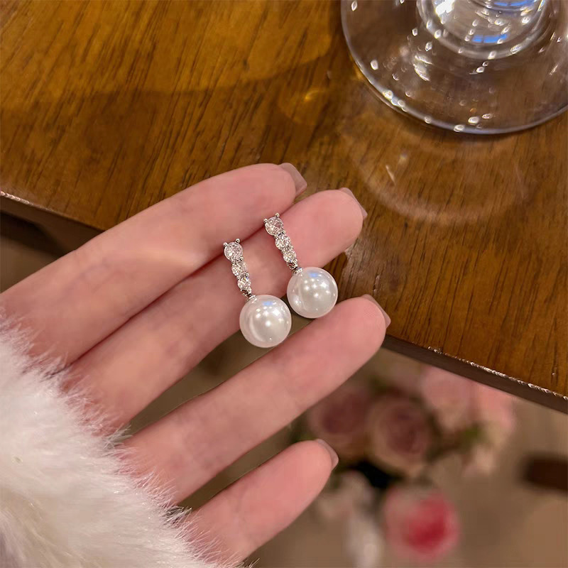 59 # Micropaved three diamond and pearl drop earrings