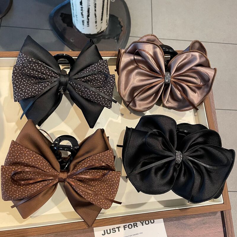 Large bow hair clip with rhinestones, a sophisticated hair accessory for creating elegant updos, a stylish shark clip for the back of the head, a high-end hair accessory from a boutique