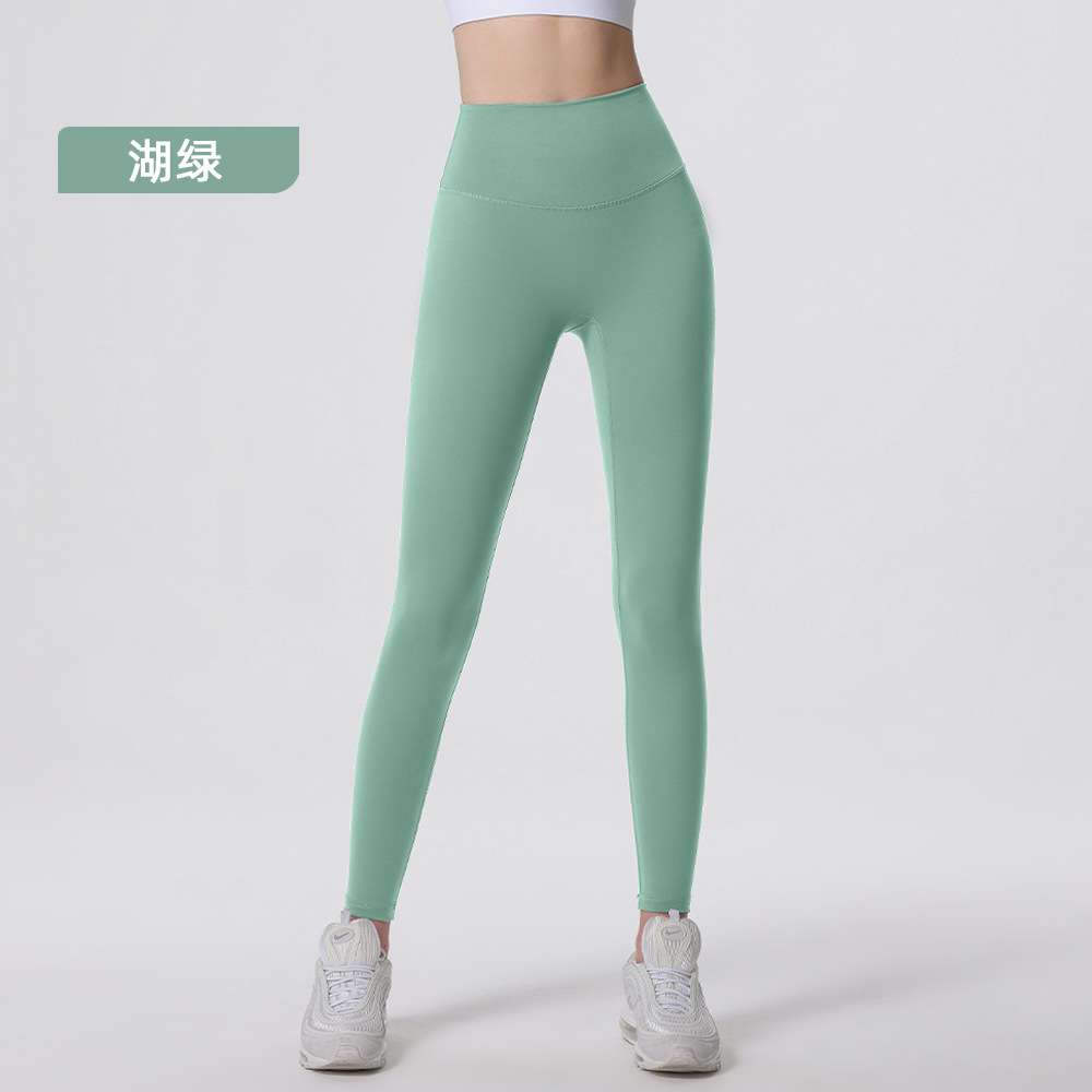 Nuevos deportes de yoga cintura alta desnuda sensación de no vergüenza línea piel-friendly levantamiento de la cadera del vientre que no se contrae la caída de la aptitud de las mujeres pantalones recortados