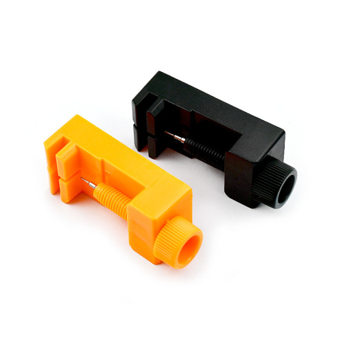 Orange plastic mini watch strap remover tool for adjusting strap length, clock repair tool