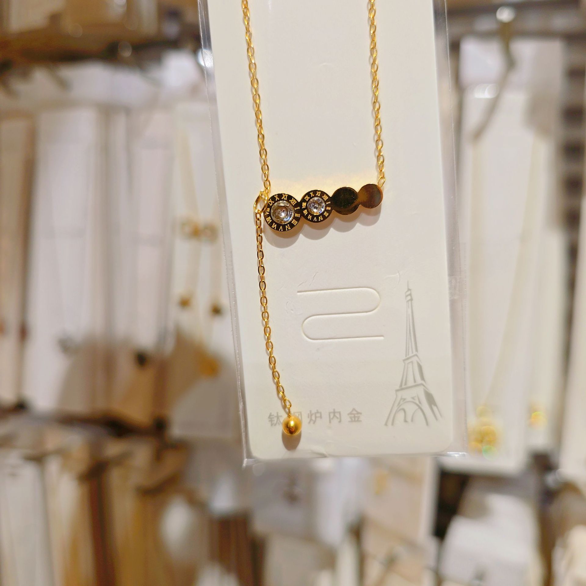 Golden necklace with tassels with zircon