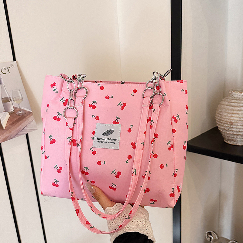 Moda pequeña y fresca impresión de cereza bolsos de invierno 2025, bolsos de mujer nuevos, bolsos de gran capacidad, bolsos de mujer de estilo exterior.