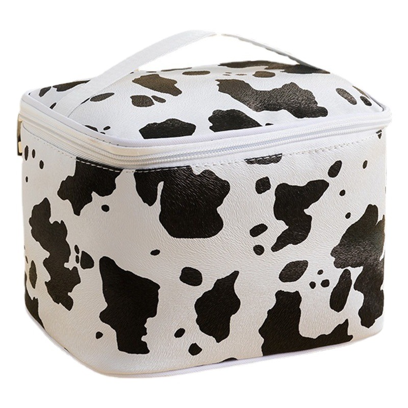 Patrón de vaca PU bolsa de cosméticos impermeable de gran capacidad de alto aspecto portátil avanzado bolsa de almacenamiento cuidado de la piel bolsa de lavado al por mayor