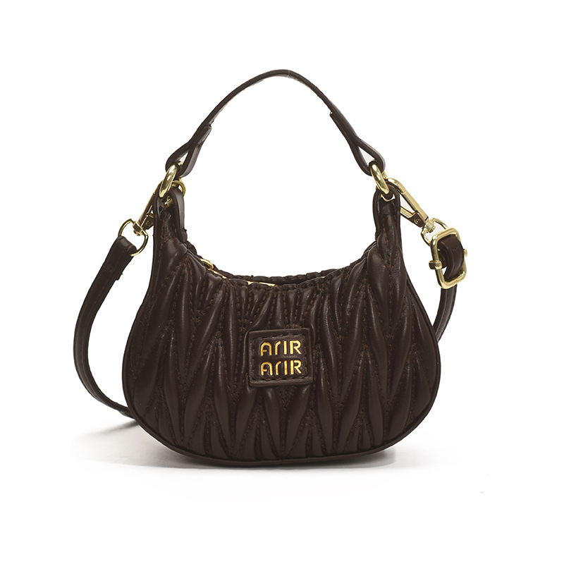 Versión coreana del bolso de hombro de niña de color sólido simple estilo occidental mini bolso de la axila portátil del bebé nuevo bolso de los niños plisado