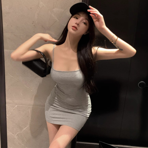 Sexy hot woman's summer casual low-cut strap dress with pure desire to show off curves, trending buttock-grazing dress