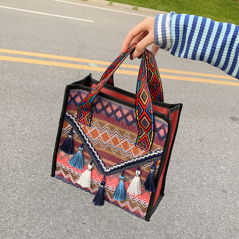 New hand-held fringed shopping bag 2022, fashionable ethnic style, Hong Kong style bucket bag, versatile woven bag for women undefined