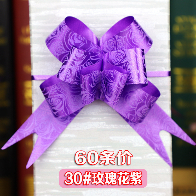 手拉花の結婚車の蝶結びの花の贈り物の包装は花の色の条を引き出して本のリボンのリボンの本を縛って賞状を縛ります。|undefined
