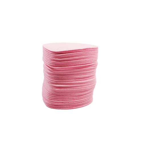 Compressed heart-shaped wood pulp cotton facial puff for washing face, cleansing, makeup removal, and powder application; can be soaked in water to transform into a large sponge facial puff.