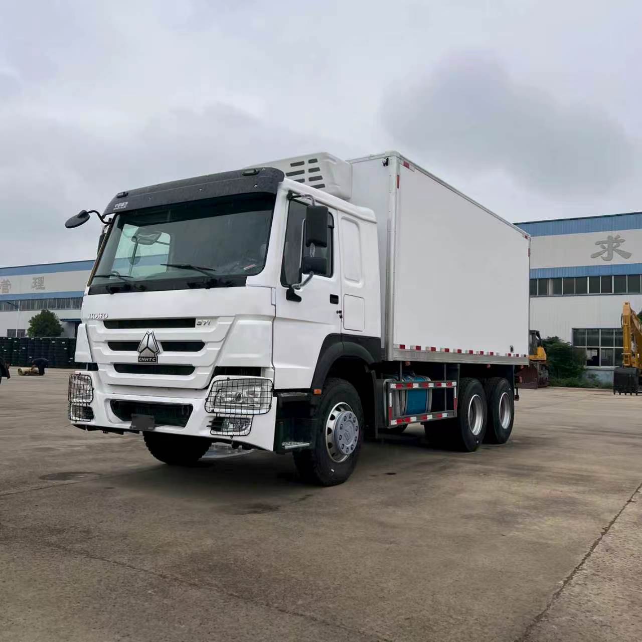 Two Howo self-loading heavy-duty trucks for transporting construction waste and soil, available in stock for direct export, wholesale purchase, and high-quality selection from manufacturers